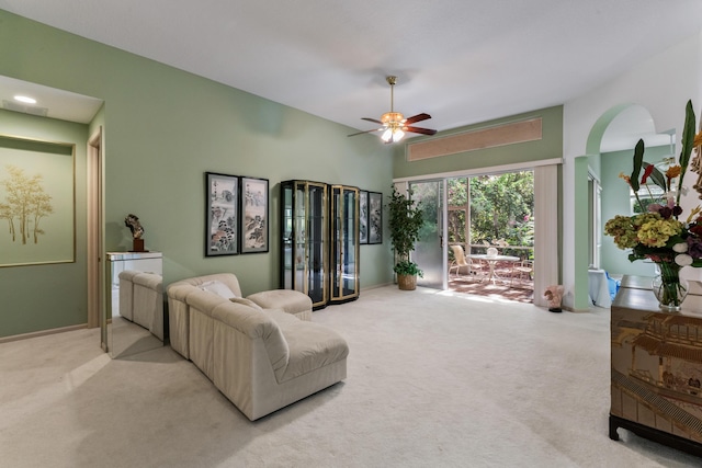 carpeted living room with ceiling fan