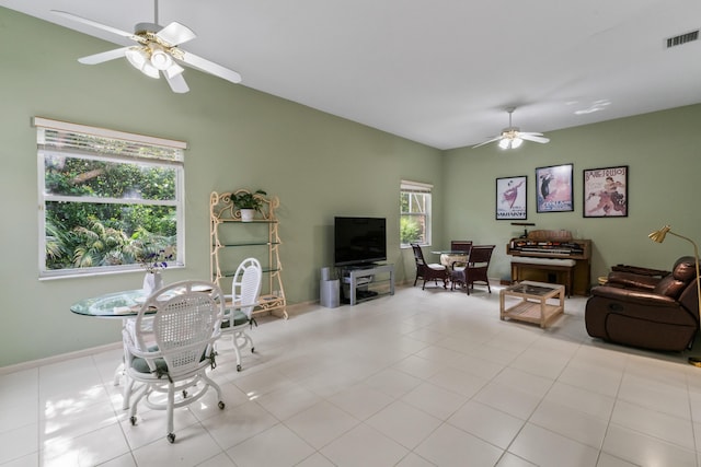 living room with vaulted ceiling, light tile patterned floors, and ceiling fan