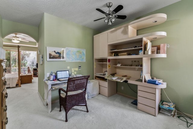 carpeted home office featuring ceiling fan and a textured ceiling