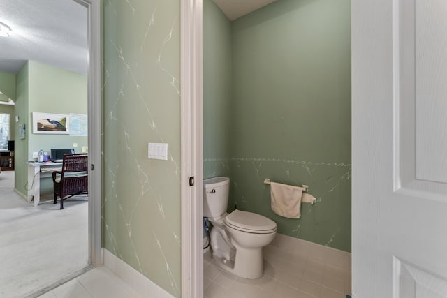 bathroom with tile patterned flooring and toilet