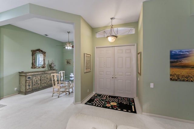 carpeted entrance foyer featuring ceiling fan