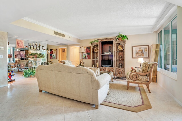 living room with light tile patterned flooring, a textured ceiling, a healthy amount of sunlight, and ornamental molding