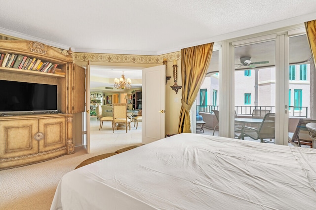 carpeted bedroom featuring an inviting chandelier, access to outside, a textured ceiling, and multiple windows