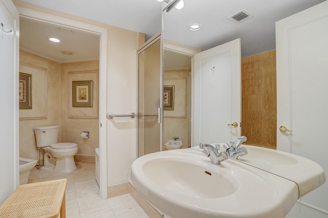 bathroom with tile patterned floors, sink, toilet, and a bidet