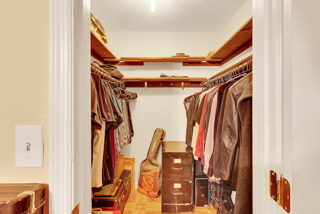 spacious closet with light tile patterned floors