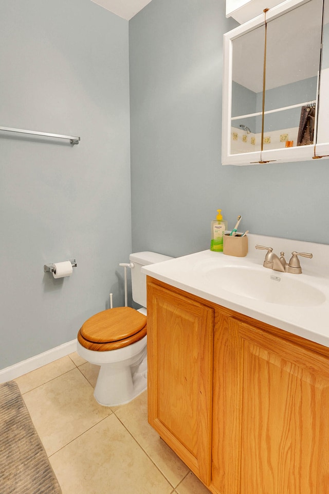 bathroom featuring vanity, tile patterned floors, and toilet