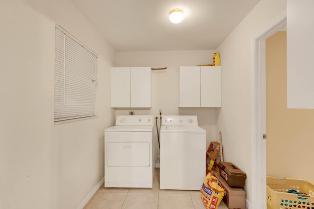 washroom featuring light tile patterned flooring, independent washer and dryer, and cabinets