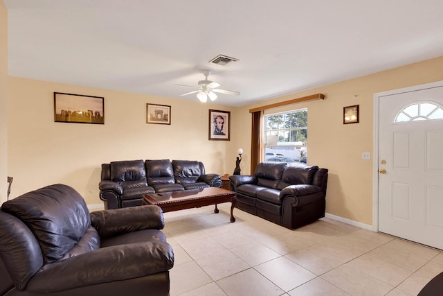 tiled living room with ceiling fan