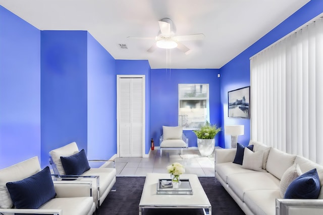 living room with ceiling fan and tile patterned flooring