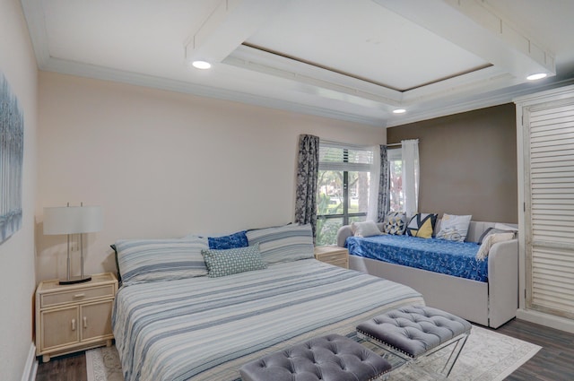 bedroom featuring a tray ceiling, dark wood-type flooring, and ornamental molding