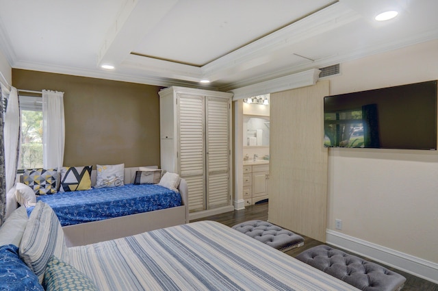 bedroom with crown molding, connected bathroom, dark hardwood / wood-style flooring, and sink