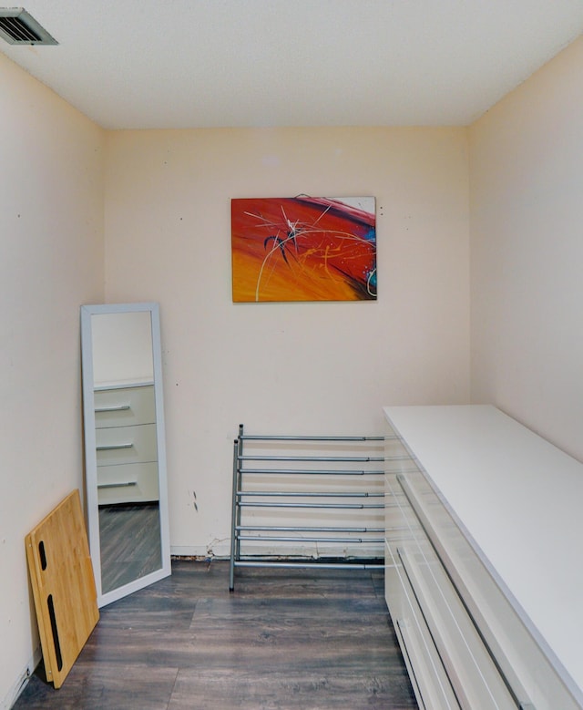 bedroom with dark wood-type flooring