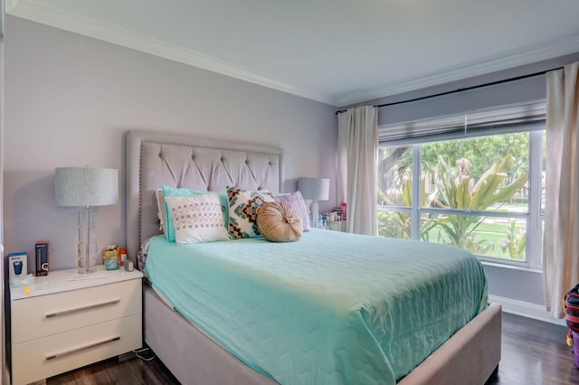 bedroom featuring ornamental molding, dark hardwood / wood-style floors, and multiple windows