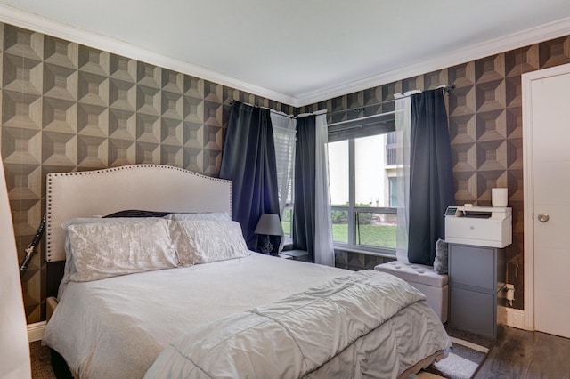 bedroom with crown molding and dark wood-type flooring