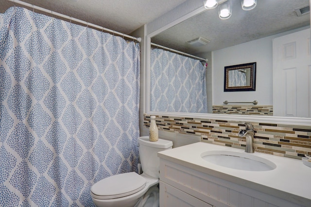 bathroom featuring vanity, toilet, a textured ceiling, and tile walls