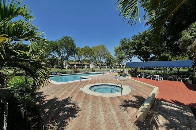 view of pool with a community hot tub and a patio