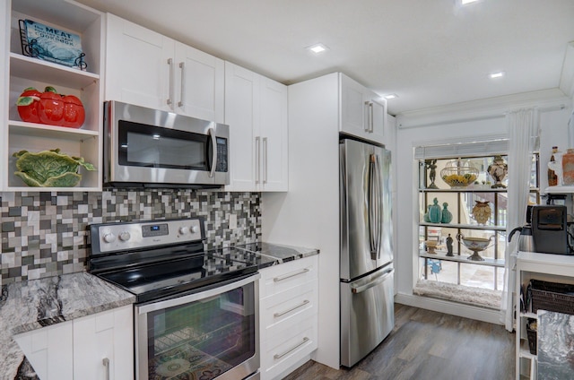 kitchen featuring stainless steel appliances, white cabinetry, stone counters, and decorative backsplash