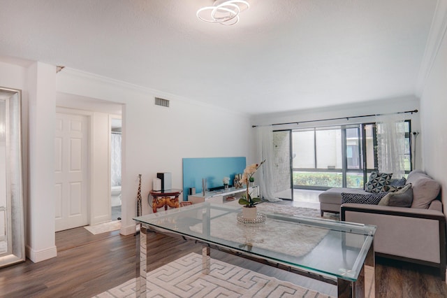 living room featuring ornamental molding and dark hardwood / wood-style flooring