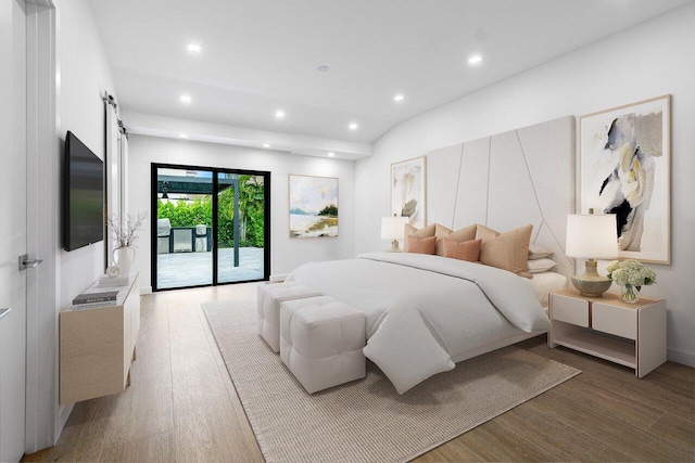 bedroom featuring a barn door, lofted ceiling, access to exterior, and light hardwood / wood-style floors