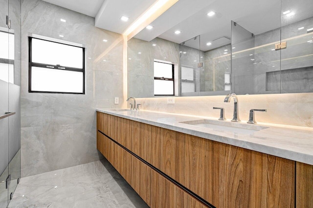 bathroom with tile walls, vanity, and a shower with shower door