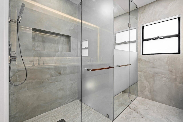 bathroom with an enclosed shower and a healthy amount of sunlight