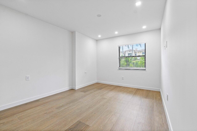 spare room featuring light hardwood / wood-style floors