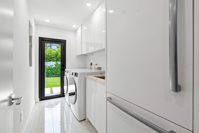 laundry area featuring cabinets and washer and clothes dryer