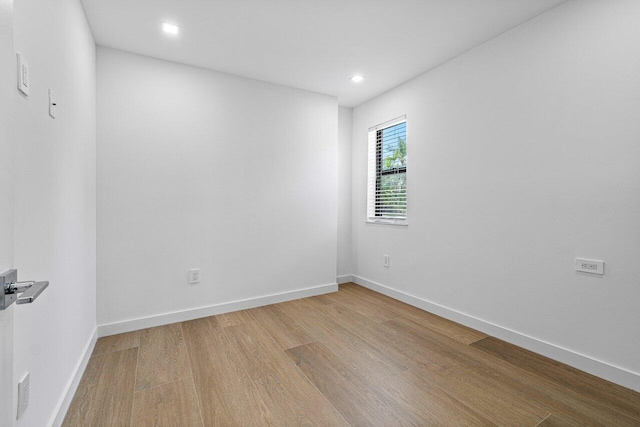 unfurnished room with hardwood / wood-style flooring