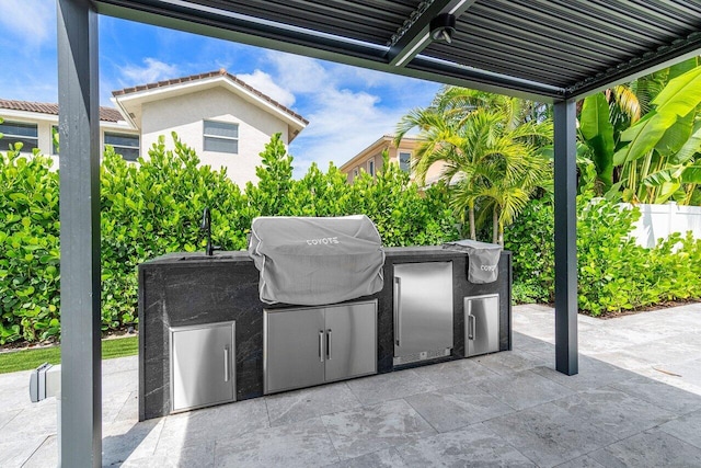 view of patio featuring exterior kitchen and grilling area