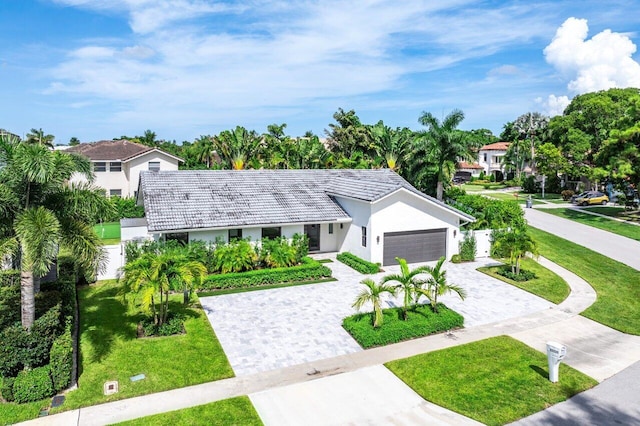 view of front of house featuring a garage and a front lawn