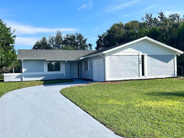 ranch-style house with a garage and a front lawn