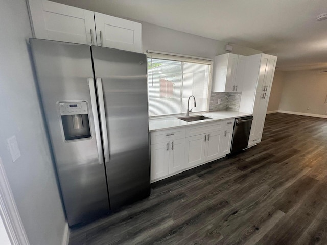 kitchen featuring stainless steel appliances, white cabinets, sink, decorative backsplash, and dark hardwood / wood-style flooring