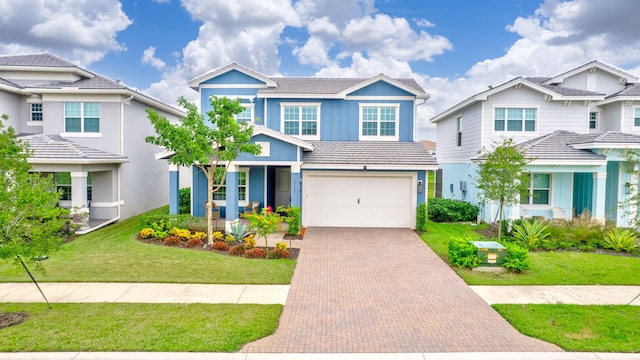 view of front of property featuring a front yard and a garage