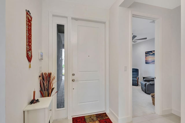 entrance foyer featuring ceiling fan and light colored carpet