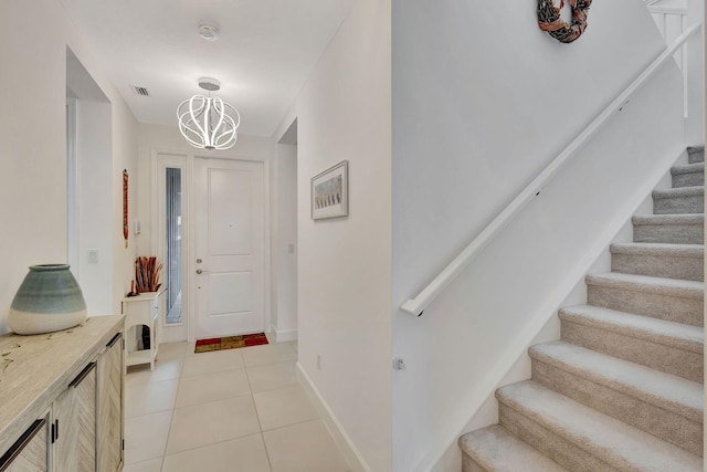 entrance foyer featuring a chandelier and light tile patterned flooring