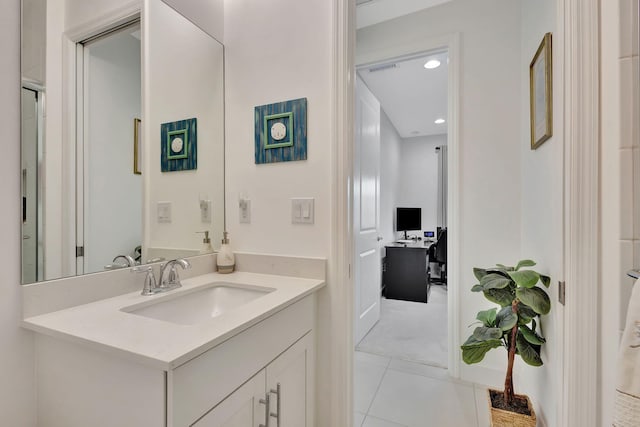 bathroom featuring tile patterned flooring and vanity