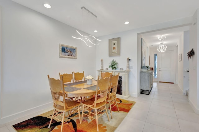 dining room with light tile patterned floors and an inviting chandelier