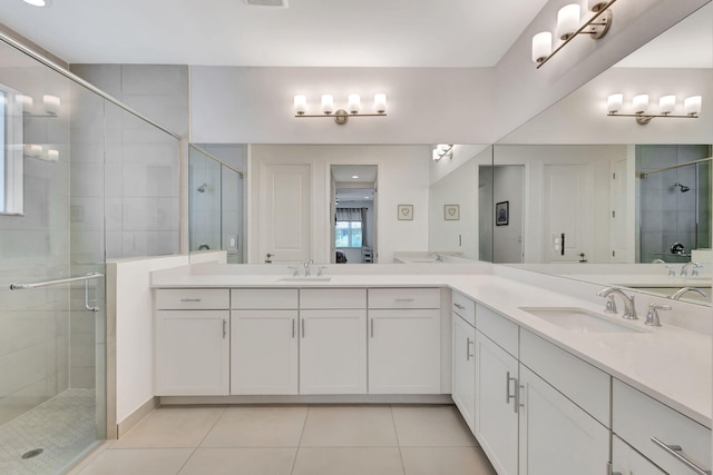 bathroom with vanity, tile patterned flooring, and an enclosed shower