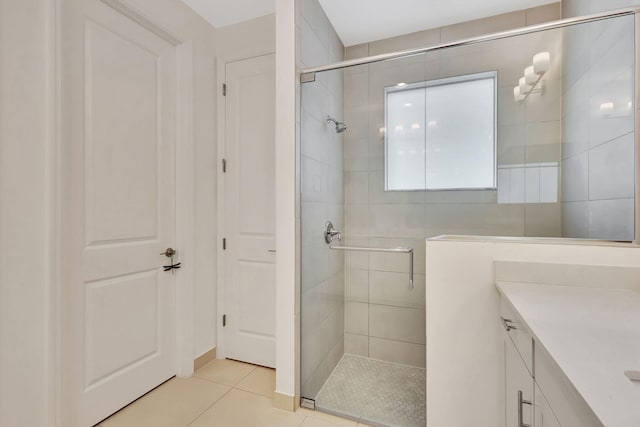 bathroom with vanity, tile patterned flooring, and a shower with door