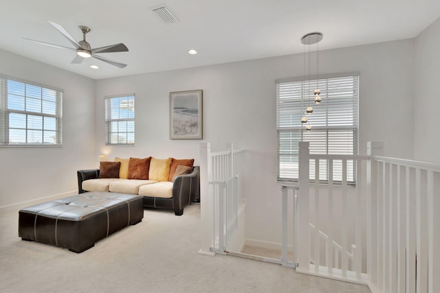 living room featuring ceiling fan and carpet flooring