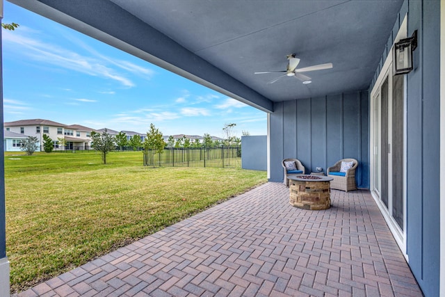 view of patio featuring ceiling fan and a fire pit