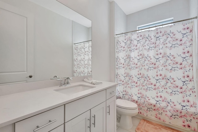 full bathroom featuring toilet, vanity, tile patterned floors, and shower / bath combo with shower curtain