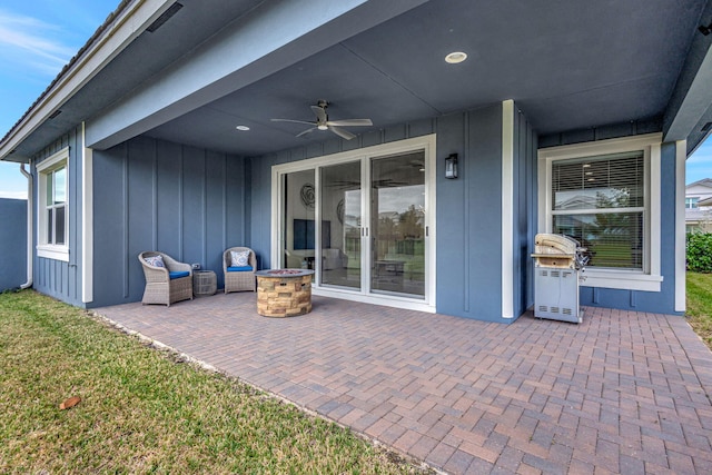 view of patio with ceiling fan and a fire pit