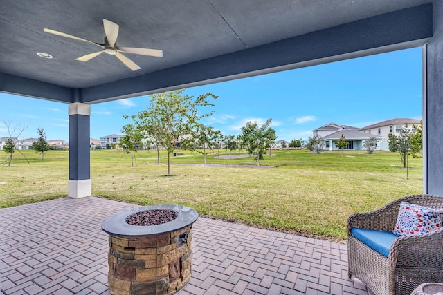 view of patio / terrace featuring ceiling fan and a fire pit