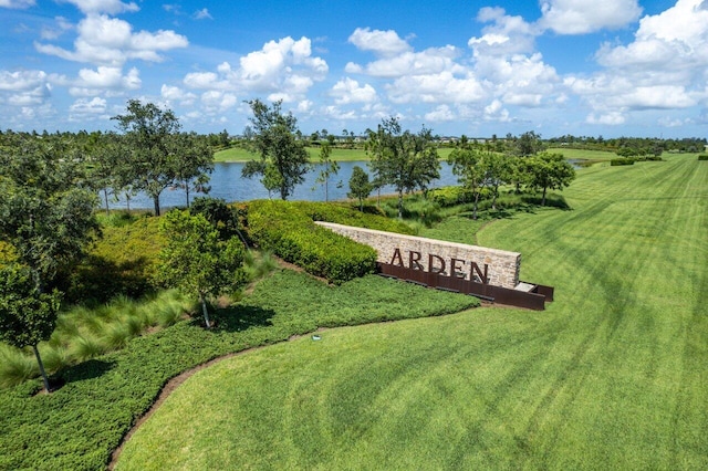 view of property's community featuring a yard, a rural view, and a water view