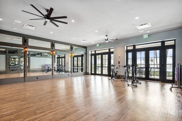 gym featuring ceiling fan, french doors, and wood-type flooring