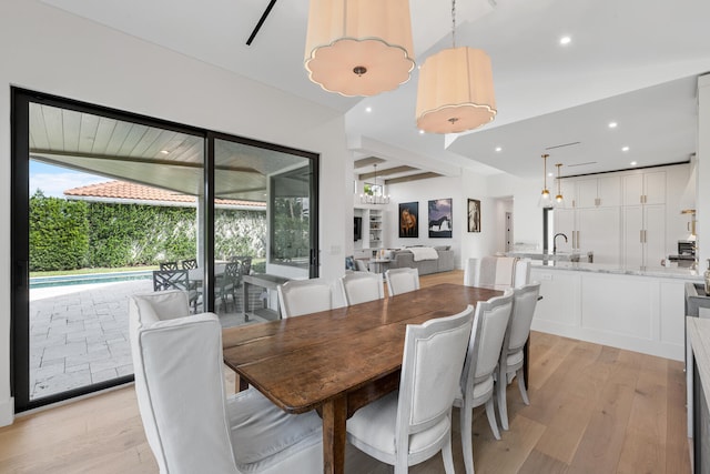 dining area featuring sink and light wood-type flooring