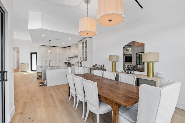 dining room with sink and light wood-type flooring