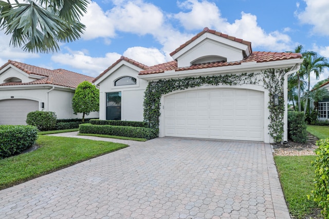 mediterranean / spanish-style house with a garage