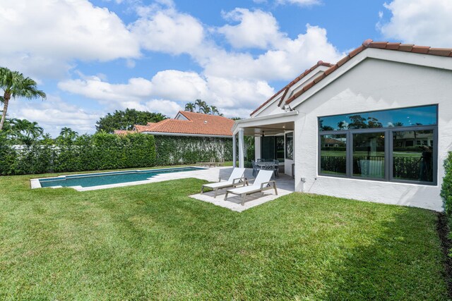 view of yard with a patio and a fenced in pool